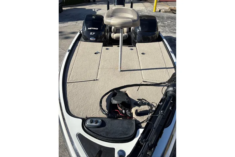 Slide: The Image of 2013 Nitro Z-7 boat deck with seating and equipment, parked outdoors. - 2