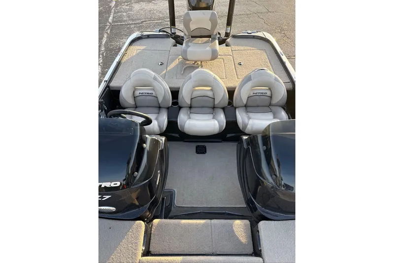 Slide: The Image of 2013 Nitro Z-7 boat interior with three cushioned seats and steering wheel. - 4