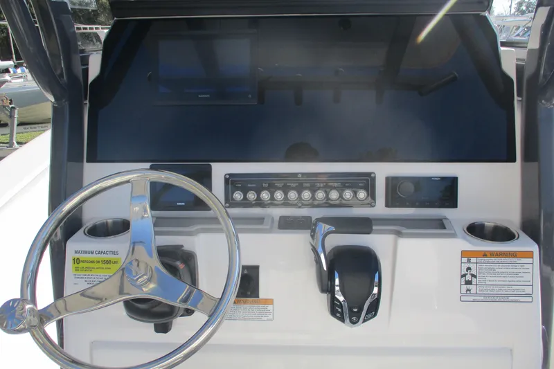 Slide: The Image of 2026 Sea Fox 248 Commander helm with steering wheel, controls, and display panel. - 10