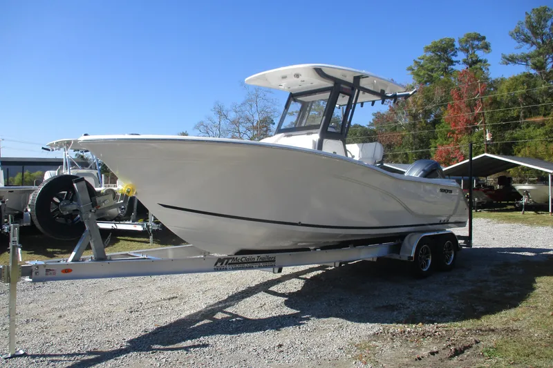 Slide: The Image of 2026 Sea Fox 248 Commander boat on trailer, parked outdoors under clear blue sky. - 3