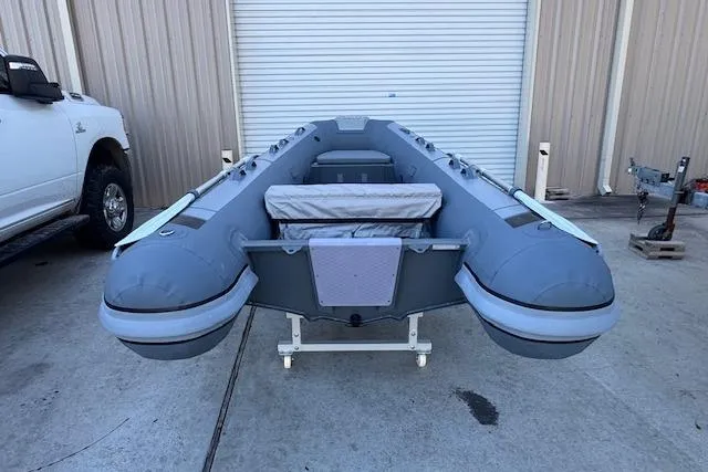 Slide: The Image of 2025 Highfield Classic 340 inflatable boat in a storage area, front view. - 2