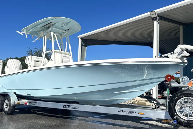 The Image of 2026 Pathfinder 2500 Hybrid boat on trailer under clear blue sky. - 0