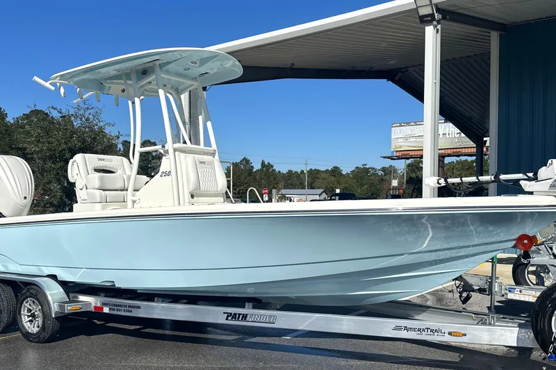 Slide: The Image of 2026 Pathfinder 2500 Hybrid boat on trailer under canopy, side view. - 23
