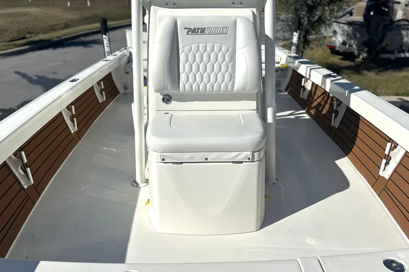 Slide: The Image of 2026 Pathfinder 2500 Hybrid boat interior with white seating and wood accents. - 3