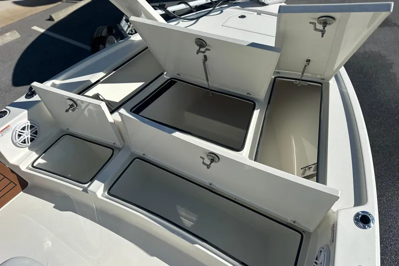 Slide: The Image of Open storage compartments on a 2026 Pathfinder 2500 Hybrid boat deck. - 4