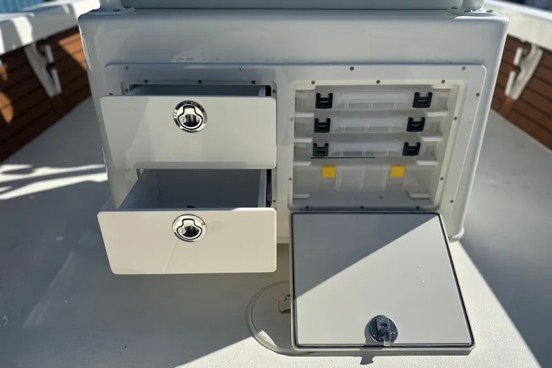 Slide: The Image of Storage compartments on a 2026 Pathfinder 2500 Hybrid boat, featuring secure drawers and tackle boxes. - 8