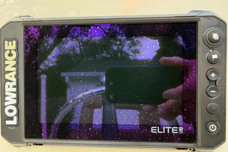 Slide: The Image of Lowrance Elite FS7 display on 2021 Pioneer 202 Islander boat, showing reflections and raindrops. - 10