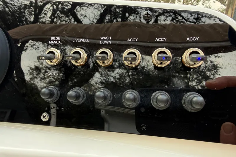 Slide: The Image of Control panel of a 2021 Pioneer 202 Islander boat with labeled switches. - 15