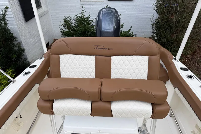 Slide: The Image of 2021 Pioneer 202 Islander boat seat with brown and white upholstery. - 17