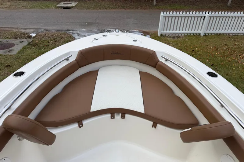 Slide: The Image of 2021 Pioneer 202 Islander boat with brown and white cushioned seating. - 19