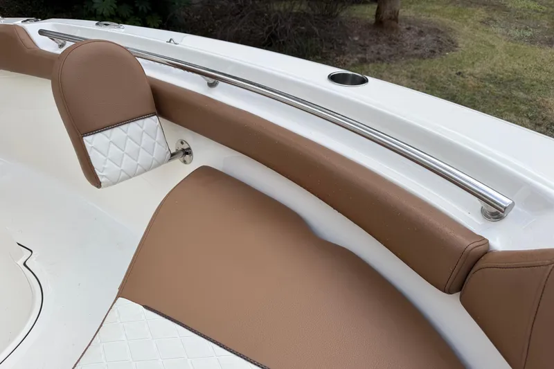 Slide: The Image of 2021 Pioneer 202 Islander boat interior with brown and white cushioned seating. - 20