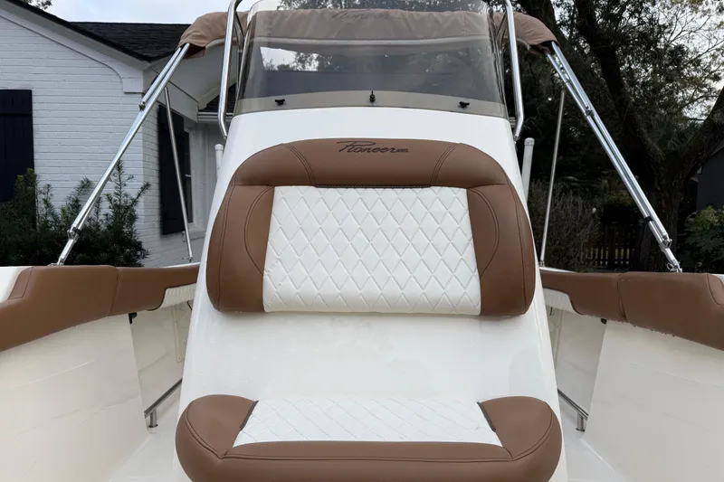 Slide: The Image of 2021 Pioneer 202 Islander boat seat with brown and white upholstery. - 25