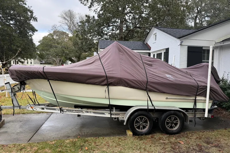 Slide: The Image of Covered 2021 Pioneer 202 Islander boat on trailer in residential driveway. - 31