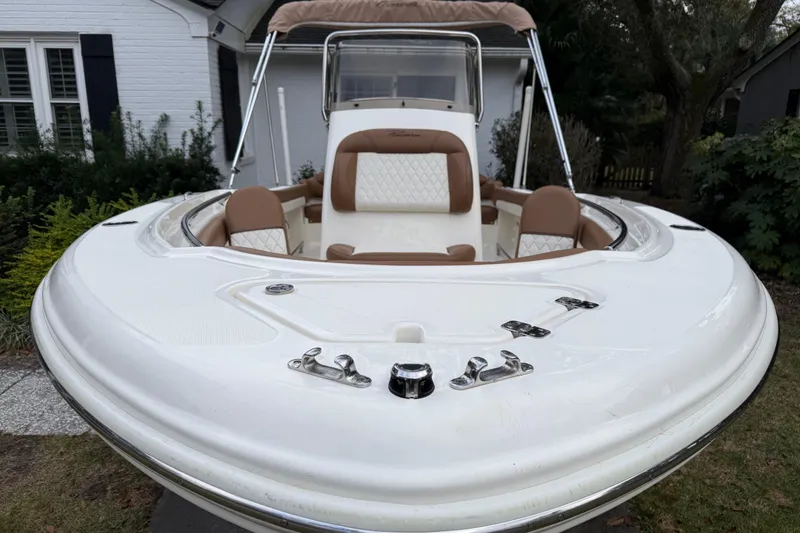 Slide: The Image of 2021 Pioneer 202 Islander boat with tan seating, parked in a residential yard. - 4