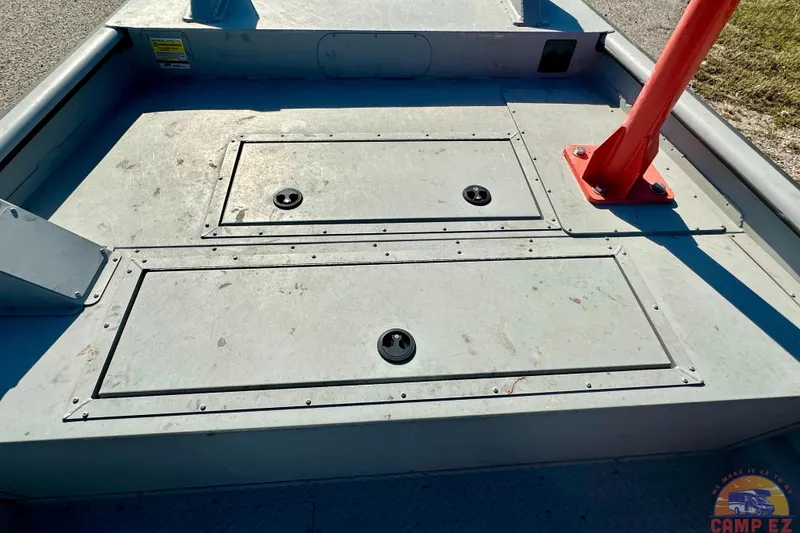 Slide: The Image of 2024 SeaArk 2672 Workhorse boat deck with storage compartments and red post. - 20