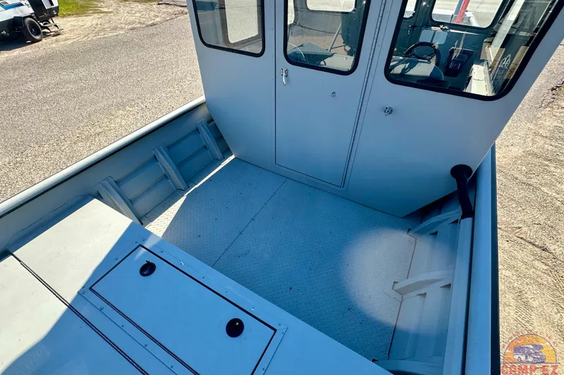 Slide: The Image of 2024 SeaArk 2672 Workhorse boat interior with spacious deck and cabin view. - 6