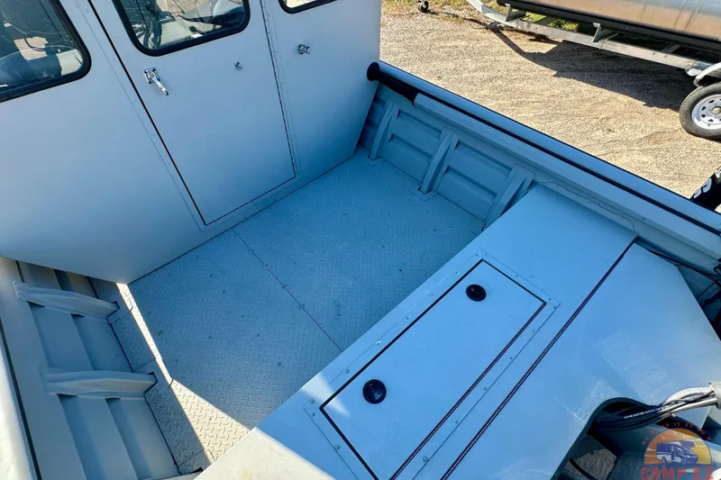 Slide: The Image of 2024 SeaArk 2672 Workhorse boat interior with storage compartments and durable flooring. - 8