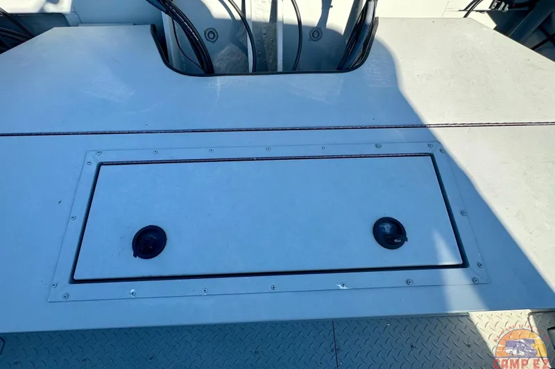 Slide: The Image of 2024 SeaArk 2672 Workhorse boat deck with storage hatch and visible wiring. - 9