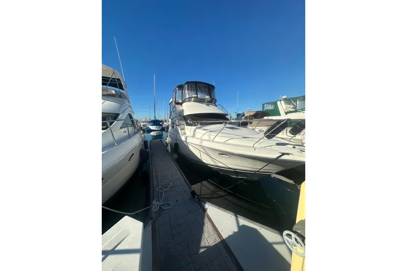 Slide: The Image of 2000 Silverton 38 yacht docked at marina under clear blue sky. - 1