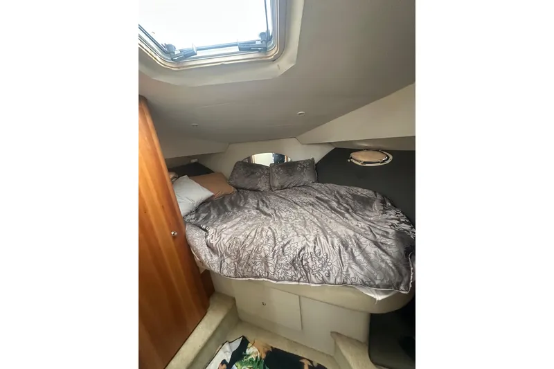 Slide: The Image of Cozy cabin interior of 2000 Silverton 38 yacht with skylight and bedding. - 11
