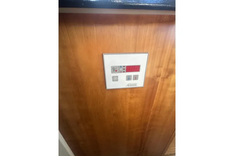 Slide: The Image of Control panel on wooden interior of 2000 Silverton 38 boat. - 13