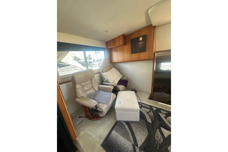Slide: The Image of Interior of 2000 Silverton 38 yacht with beige recliners and modern decor. - 14