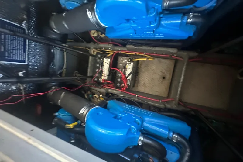Slide: The Image of Engine compartment of a 2000 Silverton 38 boat with blue engine components. - 18