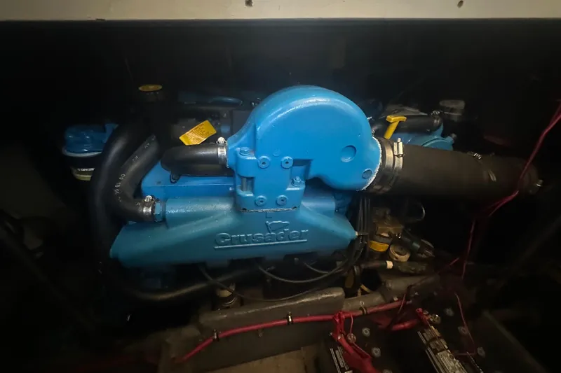 Slide: The Image of Engine of a 2000 Silverton 38 boat, featuring a blue Crusader motor. - 19