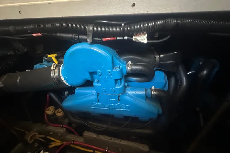 Slide: The Image of Engine compartment of a 2000 Silverton 38 with a blue Crusader engine. - 20