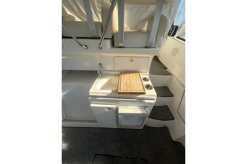 Slide: The Image of Interior of 2000 Silverton 38 boat with compact kitchenette and stairs. - 7