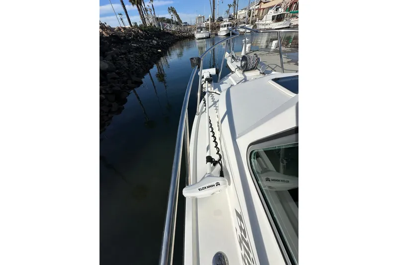 Slide: The Image of 2020 Parker 2320 Sport Cabin boat docked in a marina, sunny day, calm waters. - 15