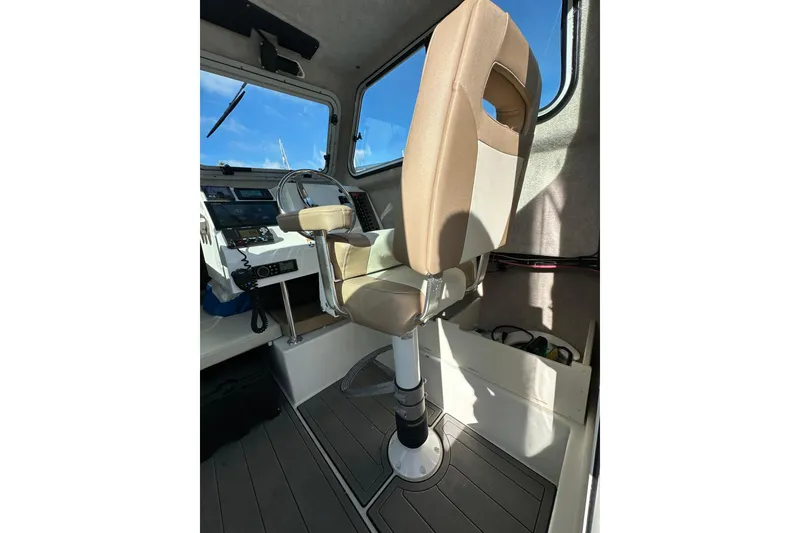 Slide: The Image of Interior of 2020 Parker 2320 Sport Cabin with captain's chair and control panel. - 18