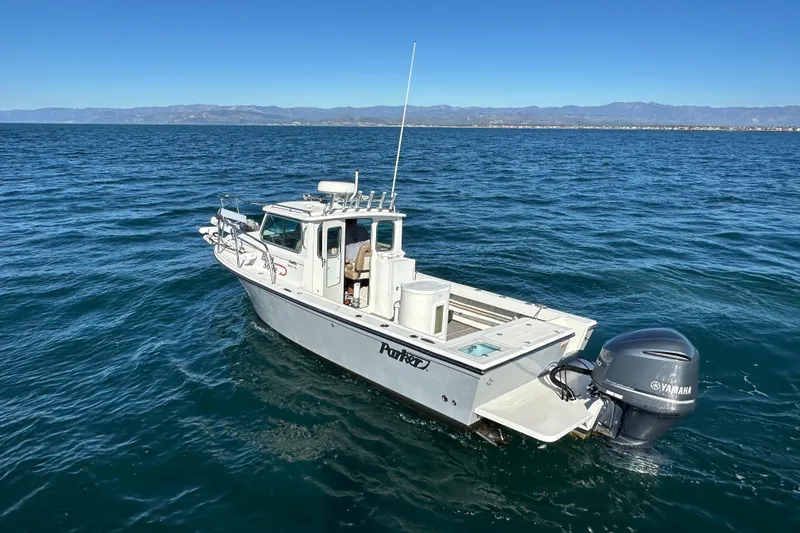 Slide: The Image of 2020 Parker 2320 Sport Cabin boat on open water with Yamaha engine. - 3