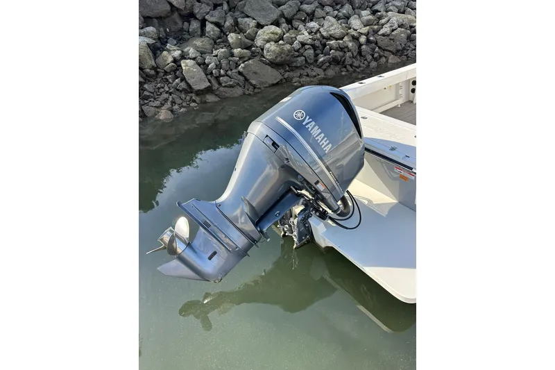 Slide: The Image of Yamaha outboard motor on 2020 Parker 2320 Sport Cabin boat, docked by rocky shore. - 5
