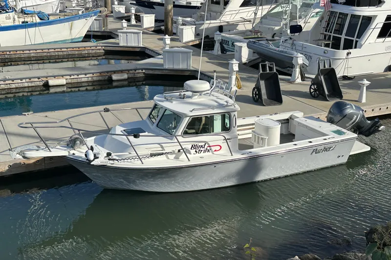 Slide: The Image of 2020 Parker 2320 Sport Cabin boat docked in marina, side view. - 6