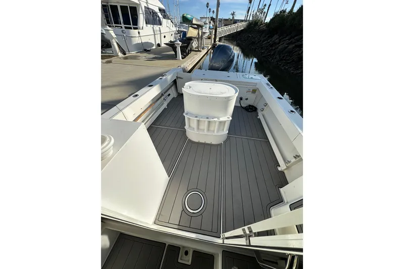 Slide: The Image of 2020 Parker 2320 Sport Cabin boat deck with clean, spacious layout at dock. - 9