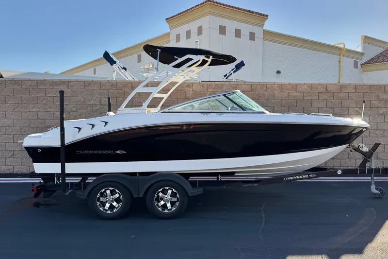 The Image of 2019 Chaparral 21 H2O Ski & Fish boat on trailer, black and white design. - 0
