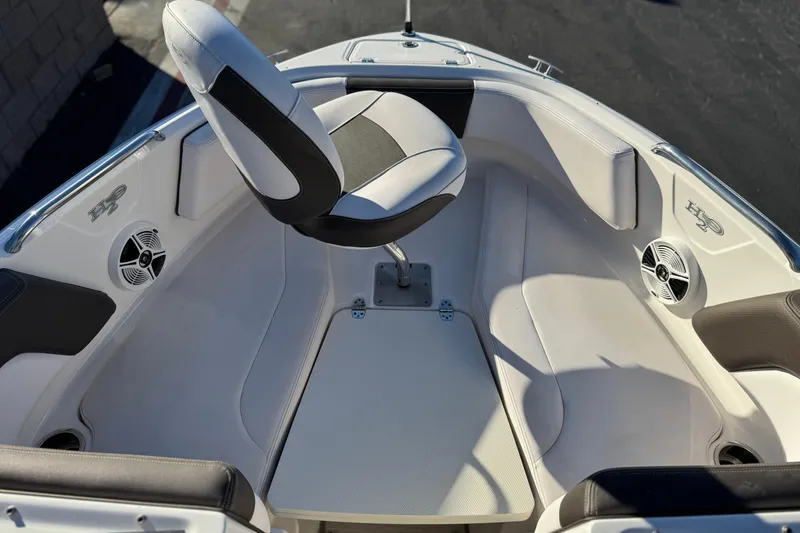 Slide: The Image of 2019 Chaparral 21 H2O Ski & Fish boat interior with seating and speakers. - 12