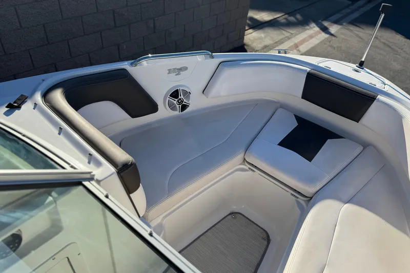 Slide: The Image of 2019 Chaparral 21 H2O Ski & Fish boat interior with cushioned seating. - 13