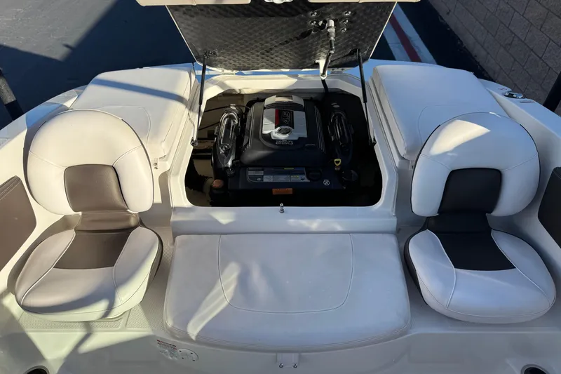 Slide: The Image of 2019 Chaparral 21 H2O Ski & Fish boat interior with engine and seating. - 18