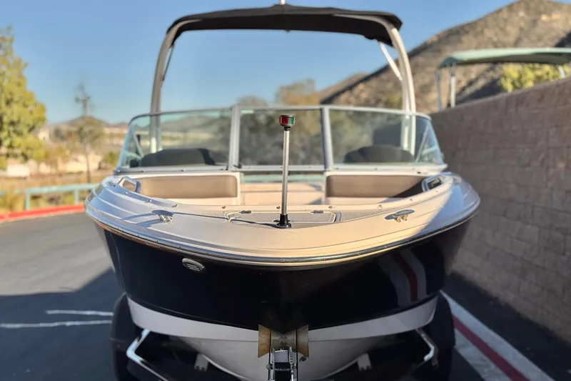Slide: The Image of 2019 Chaparral 21 H2O Ski & Fish boat, parked outdoors, front view. - 2