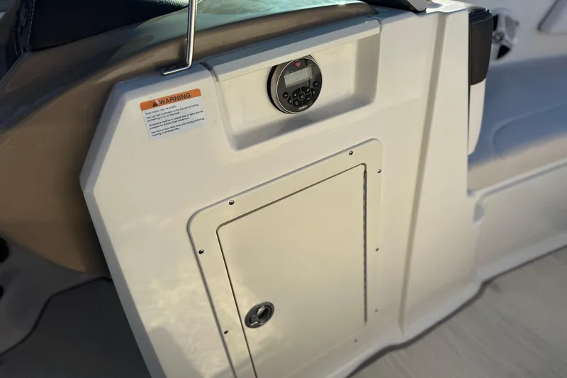 Slide: The Image of 2019 Chaparral 21 H2O Ski & Fish boat dashboard with control panel and storage compartment. - 25