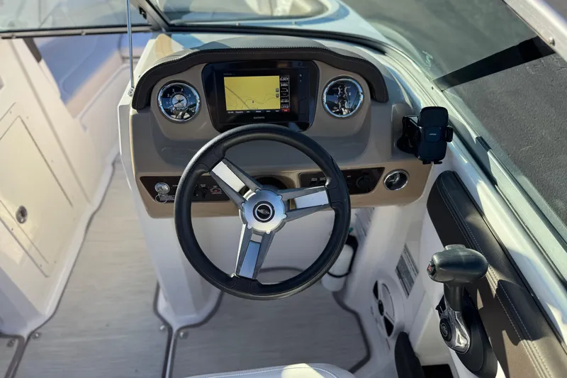 Slide: The Image of 2019 Chaparral 21 H2O Ski & Fish boat dashboard with steering wheel and controls. - 28