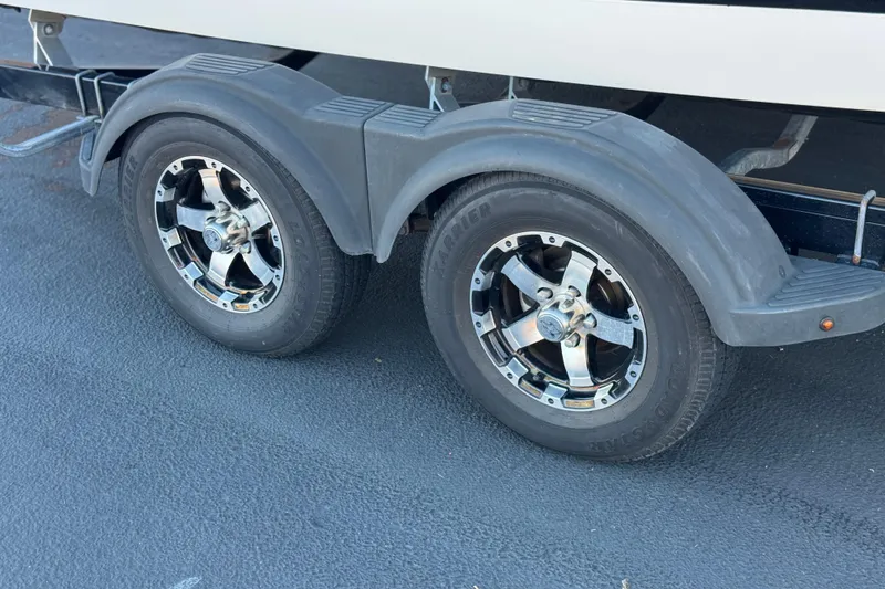 Slide: The Image of Trailer wheels of a 2019 Chaparral 21 H2O Ski & Fish boat. - 33