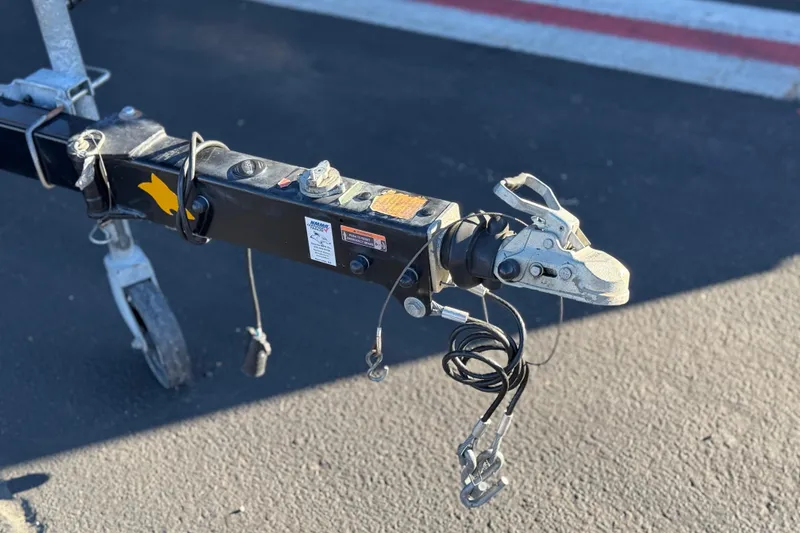 Slide: The Image of Trailer hitch of a 2019 Chaparral 21 H2O Ski & Fish boat on pavement. - 34