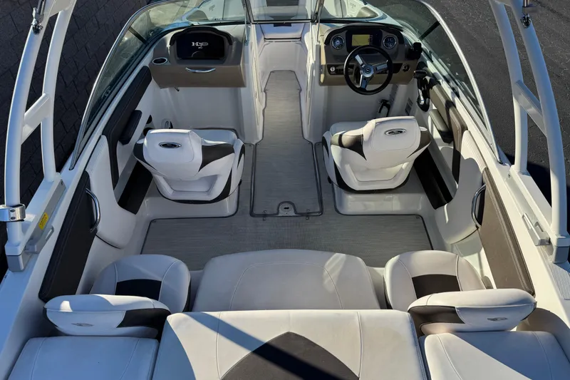 Slide: The Image of 2019 Chaparral 21 H2O Ski & Fish boat interior with seating and steering console. - 8