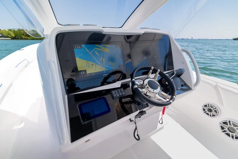 Slide: The Image of Deep Impact 369 Sport 2026 helm console on open water. - 18