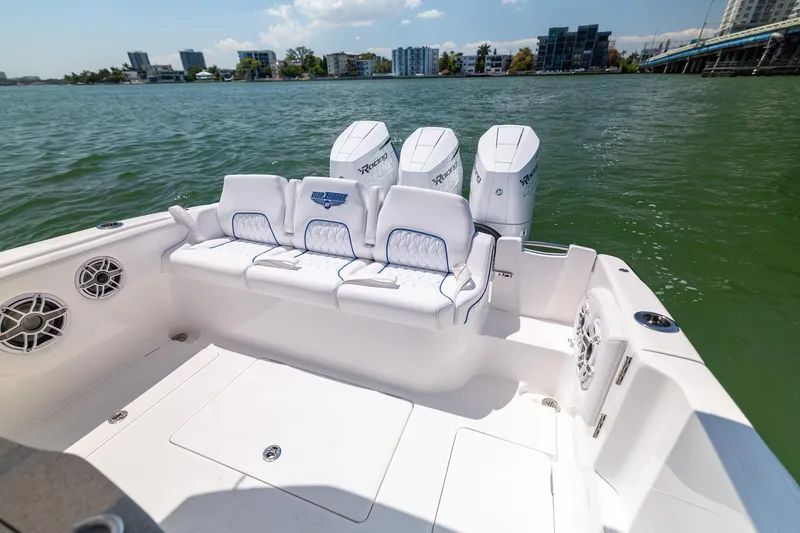 Slide: The Image of Deep Impact 369 Sport 2026 boat on calm water with triple engines. - 23