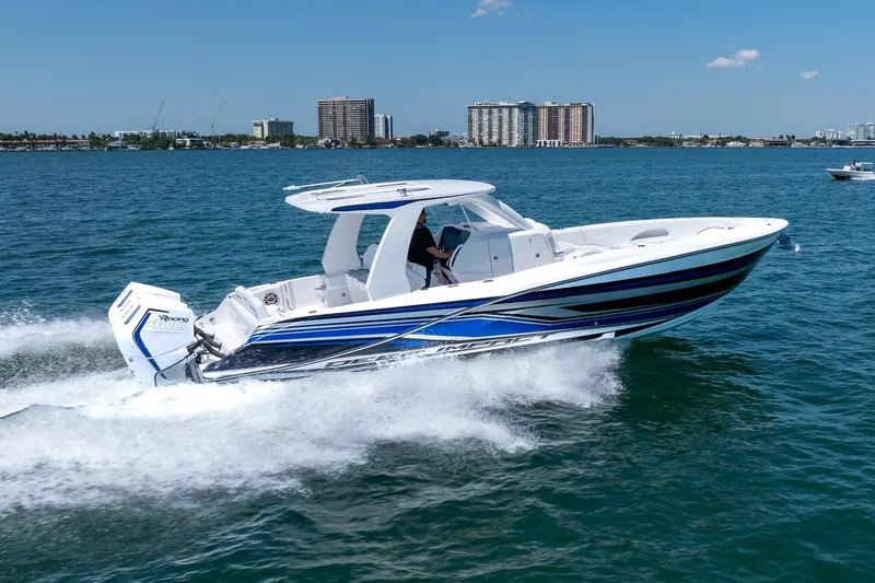 Slide: The Image of 2026 Deep Impact 369 Sport boat cruising on water. - 3