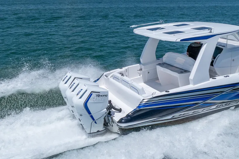 Slide: The Image of 2026 Deep Impact 369 Sport boat on water with dual outboard engines. - 4